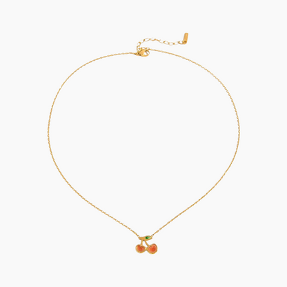 Gold necklace with cherry pendant on a white background