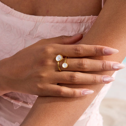 Close-up of hand adorned with gold crystal wrap ring, perfect for summer outfits