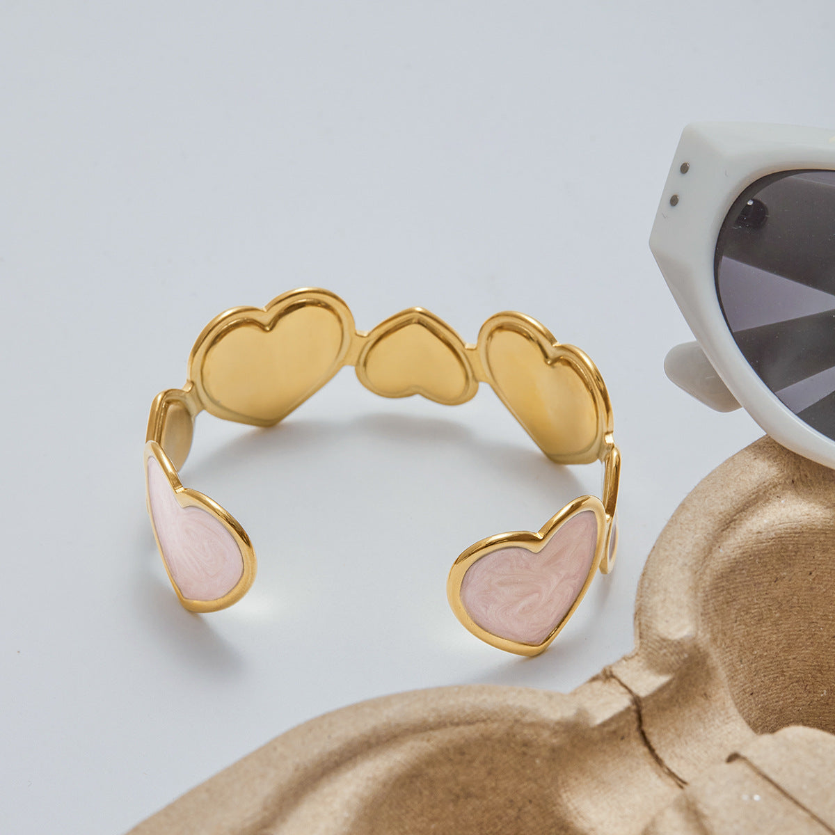 lightweight gold cuff with pastel pink heart charms