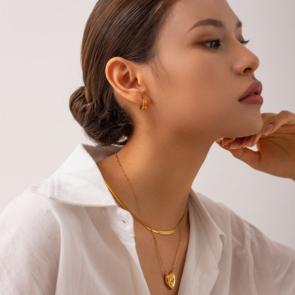 woman wearing white crystal GlowPop hoop earrings during a brunch outing
