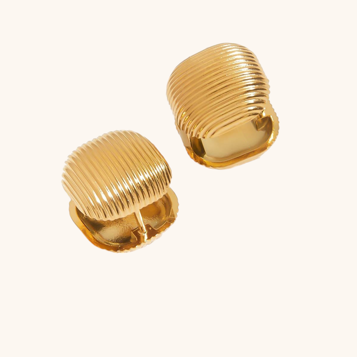 Bold gold dome clip-on earrings under natural sunlight