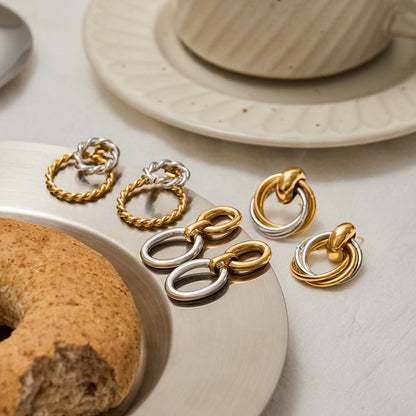 golden silver duo-toned statement earrings styled on brunch table