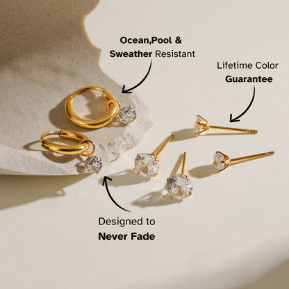 Set of round cubic zirconia earrings with gold hoops shown under natural sunlight