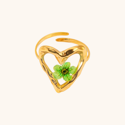 Open heart-shaped gold ring with embedded four-leaf clover for good luck