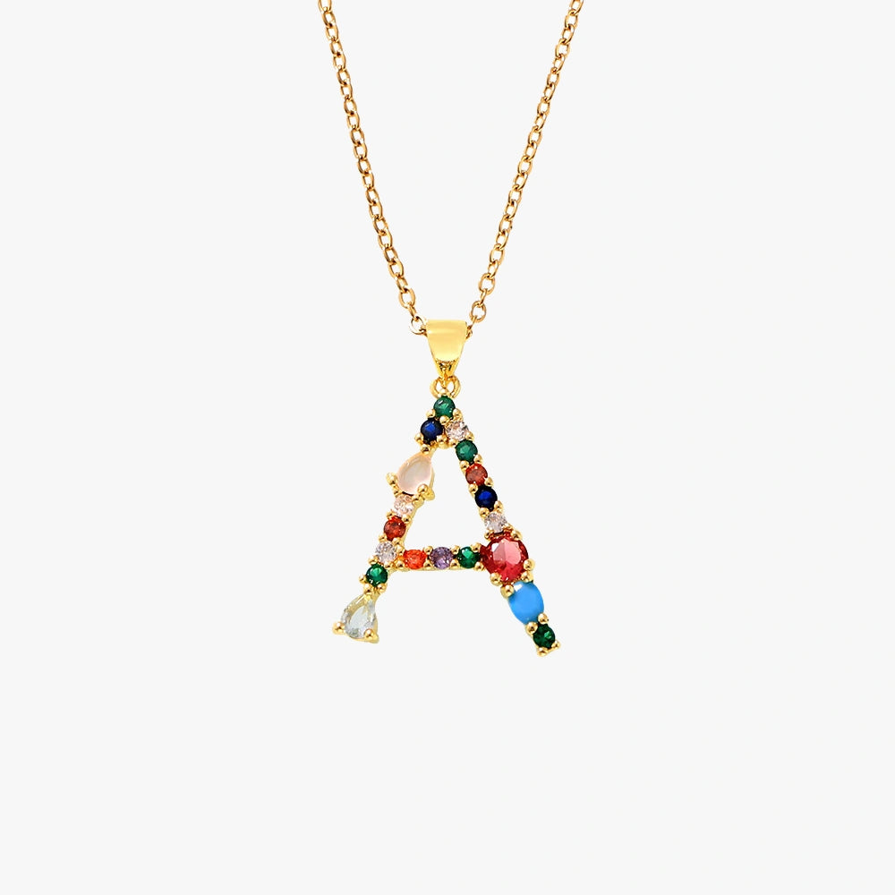 Golden pendant featuring the letter A, adorned with colorful zircon stones in red, blue, and yellow on a delicate chain.