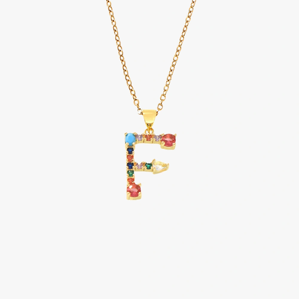 Gold letter F pendant necklace featuring colorful zircon stones in red, blue, and yellow, strung on a delicate chain.