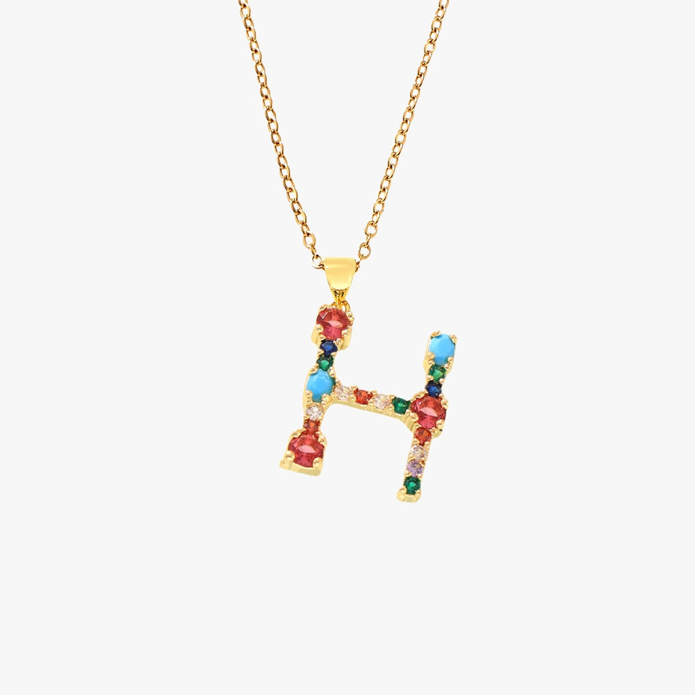 Golden letter H pendant with a variety of colorful zircon stones, hanging from a golden chain.