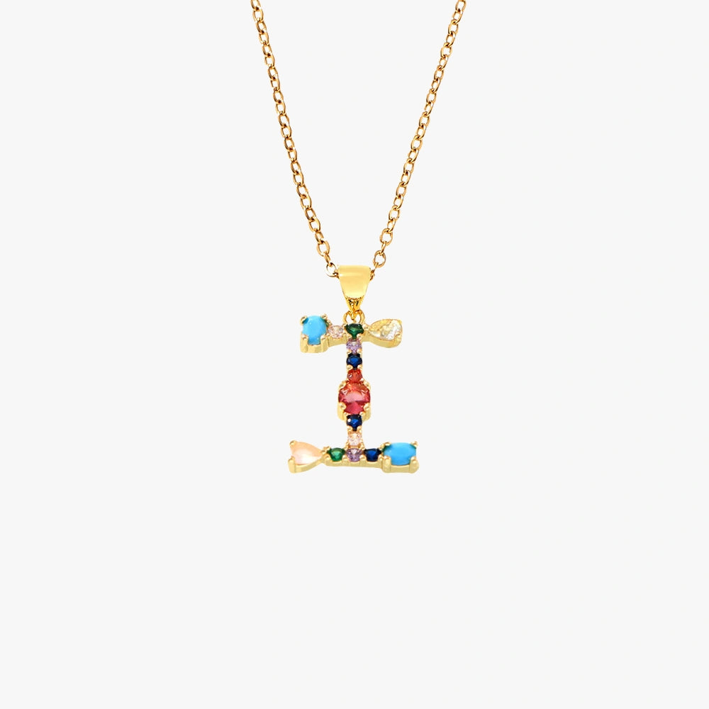 Golden pendant featuring the letter I, decorated with red, green, and blue zircon stones on a delicate gold chain.