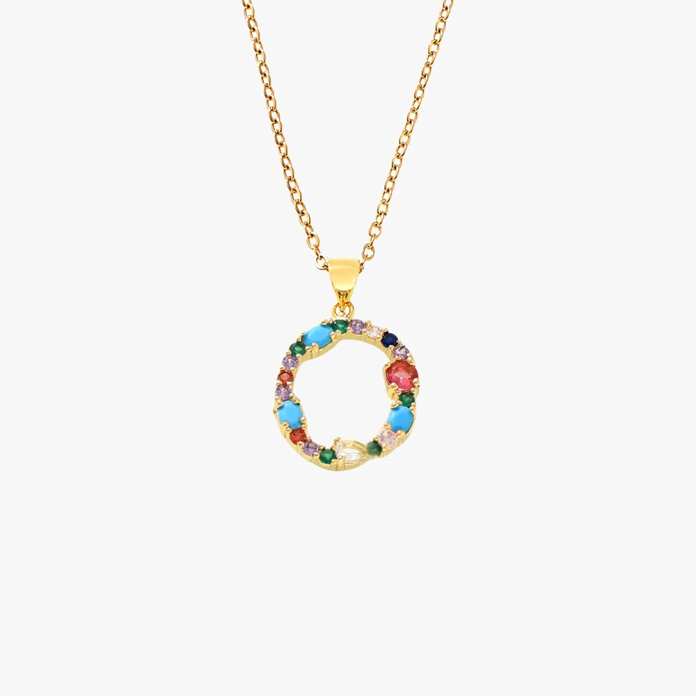 Golden letter O pendant adorned with colorful zircon stones in red, blue, and green on a delicate chain.