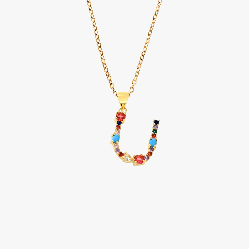 Golden pendant featuring the letter U, decorated with colorful zircon stones in red, blue, and yellow, strung on a delicate chain.