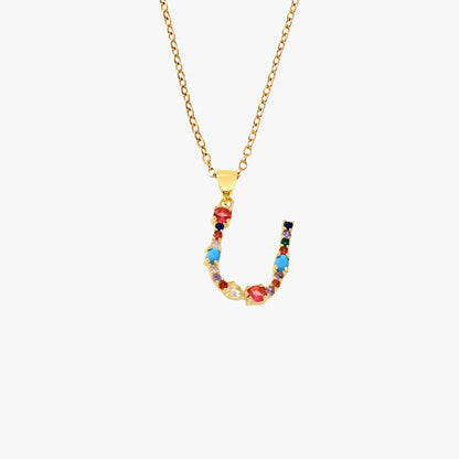 Golden pendant featuring the letter U, decorated with colorful zircon stones in red, blue, and yellow, strung on a delicate chain.