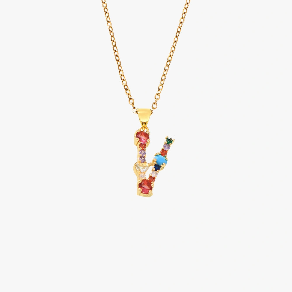 Gold letter V pendant with a vibrant mix of colorful zircon stones, suspended from a fine gold chain.
