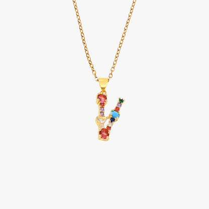 Gold letter V pendant with a vibrant mix of colorful zircon stones, suspended from a fine gold chain.