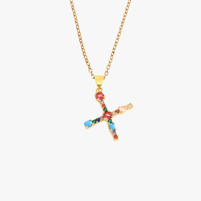 Gold pendant in the shape of the letter X, adorned with vibrant zircon stones in red, blue, and yellow, on a fine gold chain.
