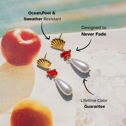 Gold shell earrings with coral and pearl accents on beach backdrop – lightweight waterproof earrings for summer holiday looks