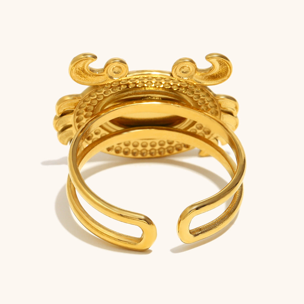 Backside detail of adjustable crab ring in polished gold, open band design.