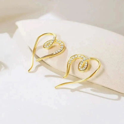 Crafted from gold with delicate crystal accents, these earrings are the perfect statement piece for any occasion.