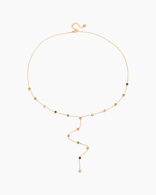 Gold necklace with small beads on a white background