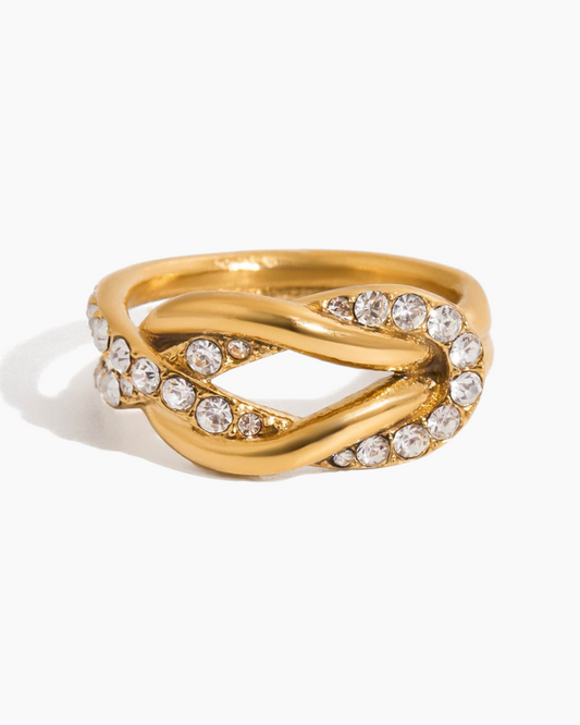 Gold ring with diamond accents on a white background