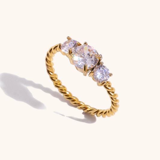 Twisted gold ring with three large sparkling crystals