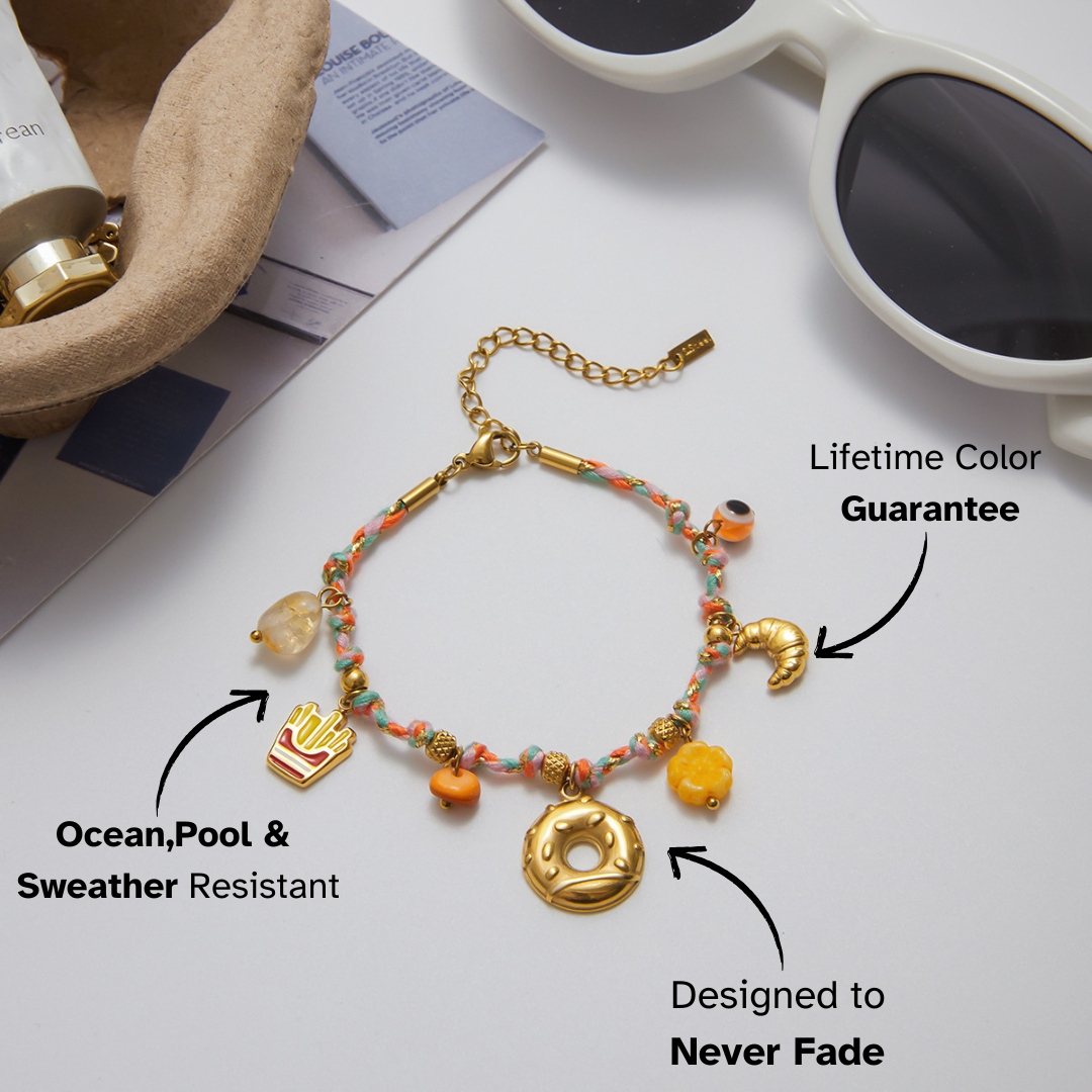 Gold food pendant bracelet with fries, donut, and gemstone