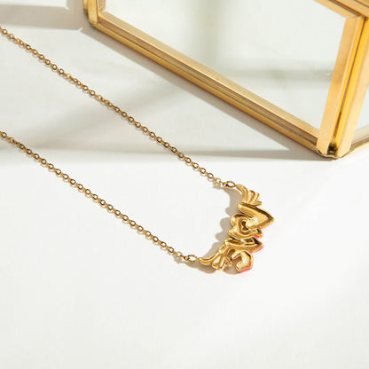 Minimalist gold enamel love necklace styled in daylight flatlay