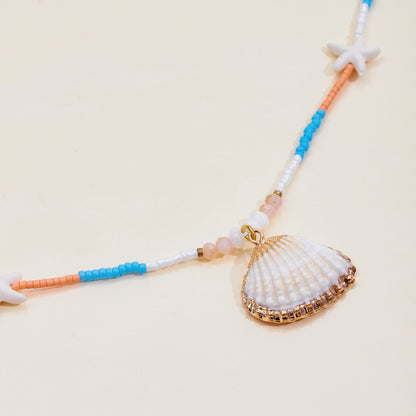 Fun and playful beach necklace with white shell pendant and colorful seed beads