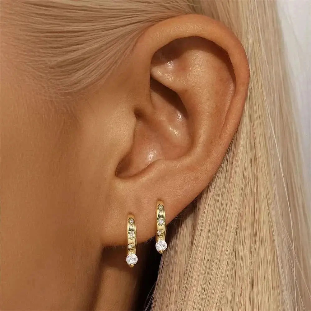 Dainty Crystal-Studded Hoops – These gold hoops with tiny crystals are the perfect blend of elegance and simplicity, ideal for stacking or wearing alone.