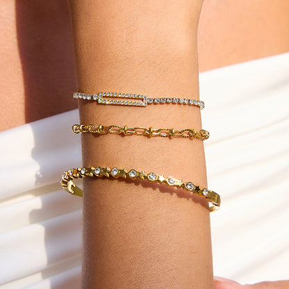 Minimalist gold bracelet stack with heart and textured chains, waterproof summer jewelry