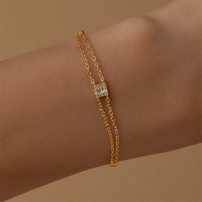 Minimalist gold-plated bracelet featuring cubic zirconia accents, perfect for layering.