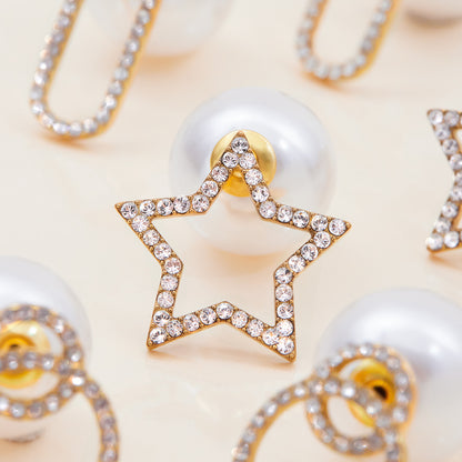 Close-up of gold star earrings with crystal detailing and large pearl back