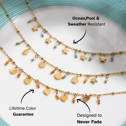 Celestial charm necklace with colorful accents on jewelry tray