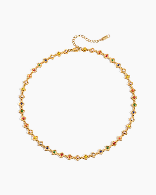 Gold necklace with colorful beads on a white background