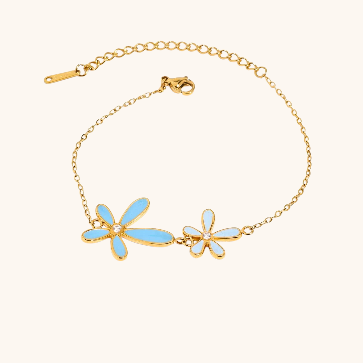 Gold chain bracelet with blue enamel daisy flowers and crystal center details