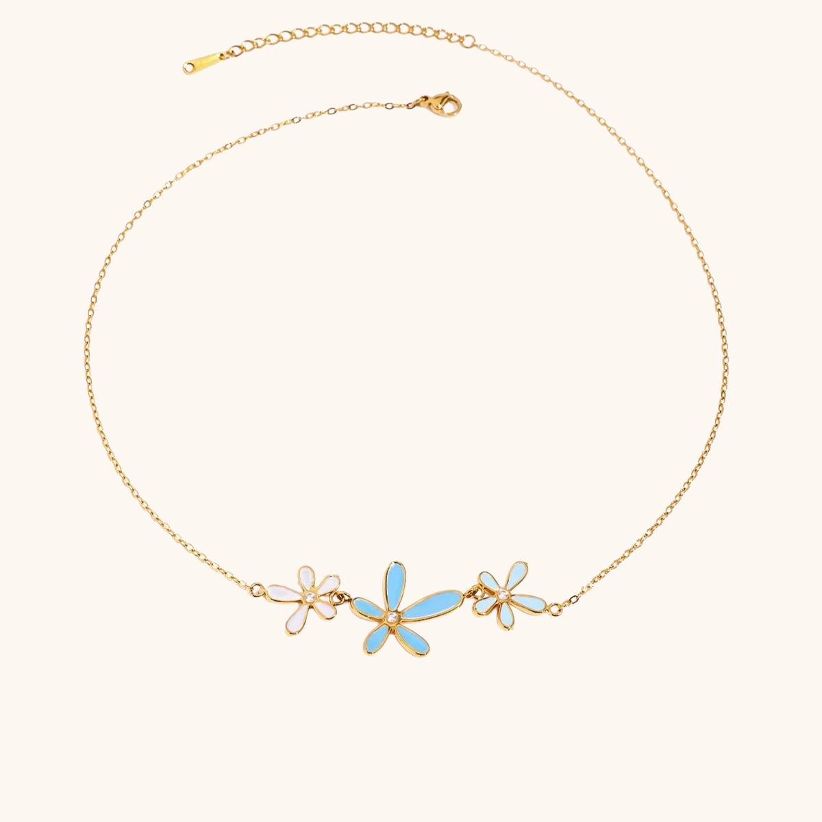 Gold chain necklace with blue enamel daisy flowers and crystal center details