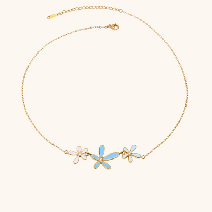 Gold chain necklace with blue enamel daisy flowers and crystal center details