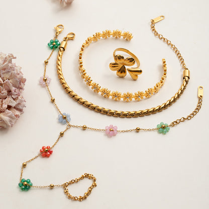 Waterproof gold floral hand bracelet styled with picnic outfit in sunny garden