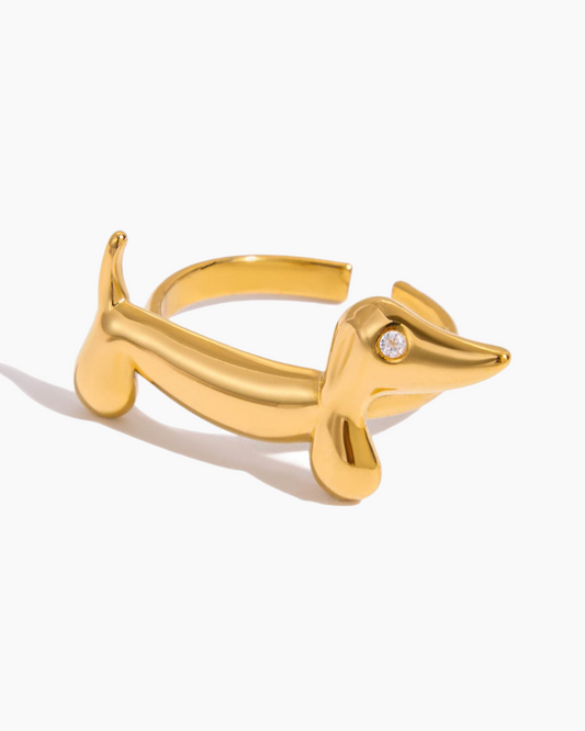 Gold dog-shaped ring with a diamond on a white background