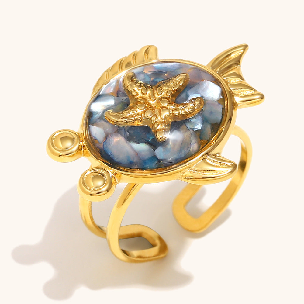 Blue mother-of-pearl ring with gold starfish in fish shape