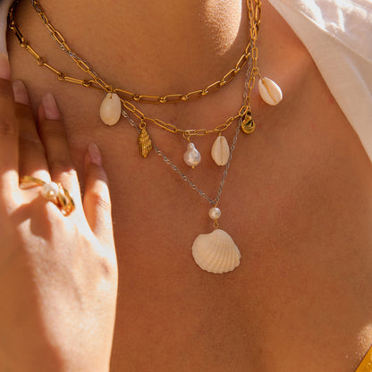 Model wearing layered shell necklace with V-neck white top_MiFJewelry