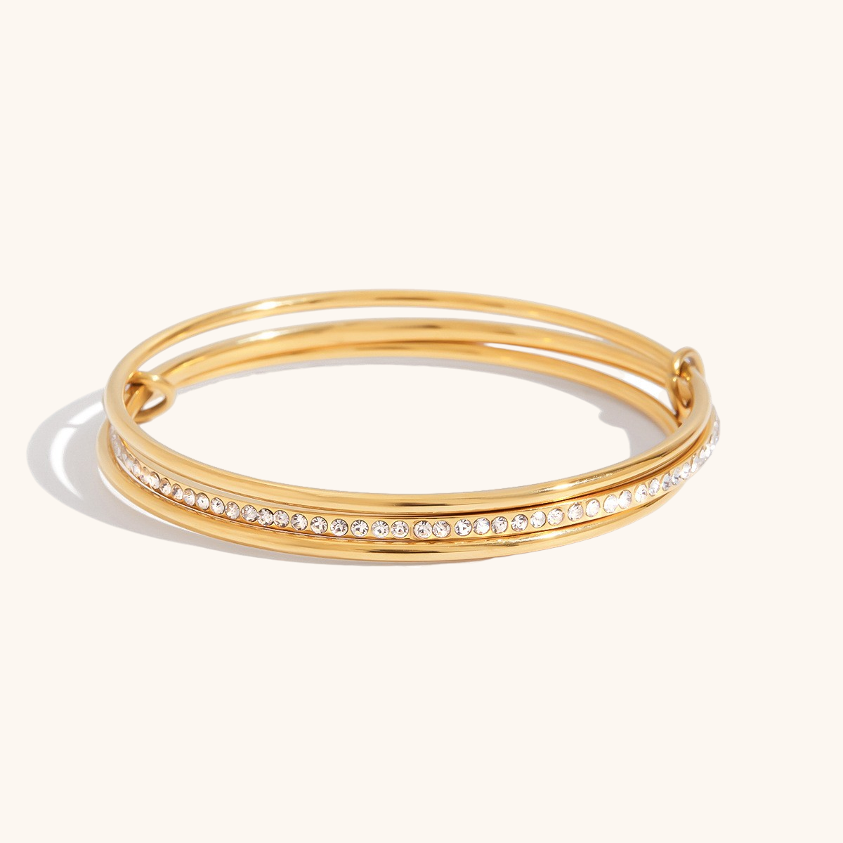 Close-up of double bangle with sparkling zircon stones on white background