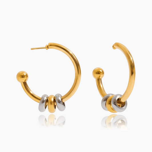 Gold hoop earrings with silver accents on a white background