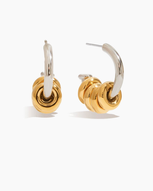 Pair of gold and silver hoop earrings on a white background