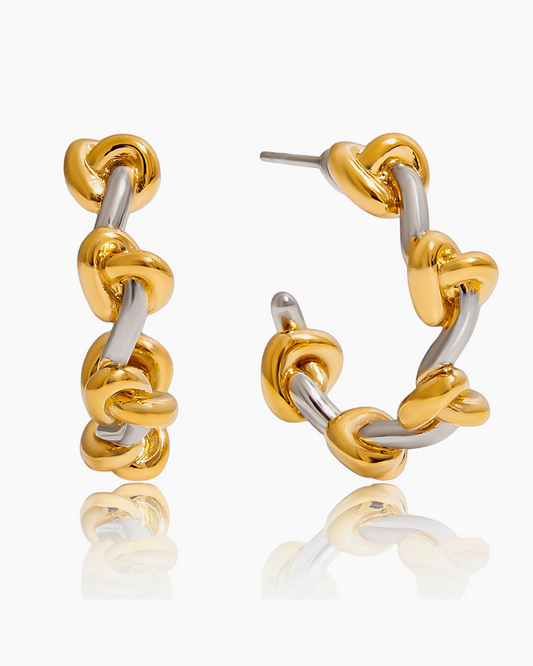 Gold and silver hoop earrings on a white background