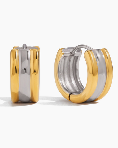 Two-tone gold and silver hoop earrings on a white background