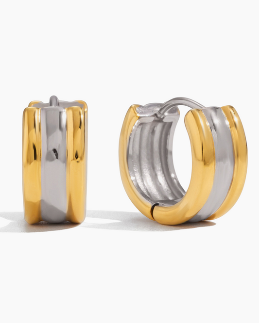 Two-tone gold and silver hoop earrings on a white background