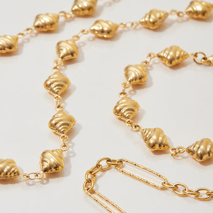 Eco-friendly 100% waterproof golden bead bracelet with gemstone accents worn in beach setting