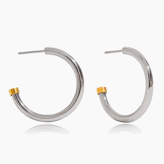 Silver hoop earrings with gold accents on a white background