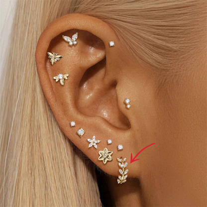 Gold hoop earring with leaf design and zirconia stones