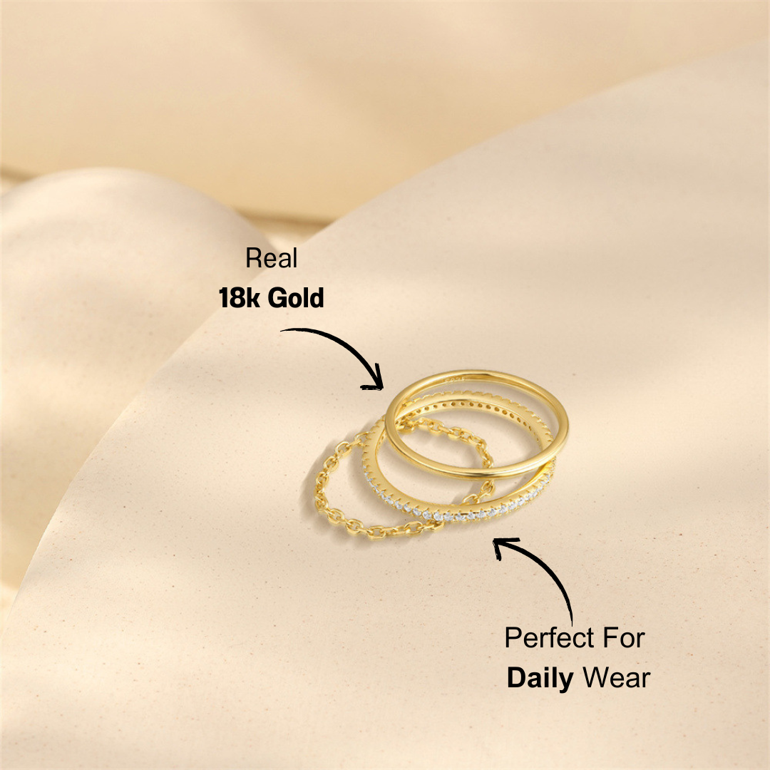 Close-up view of a gold-plated 925 sterling silver 3-piece ring set featuring zirconia stones on soft beige background